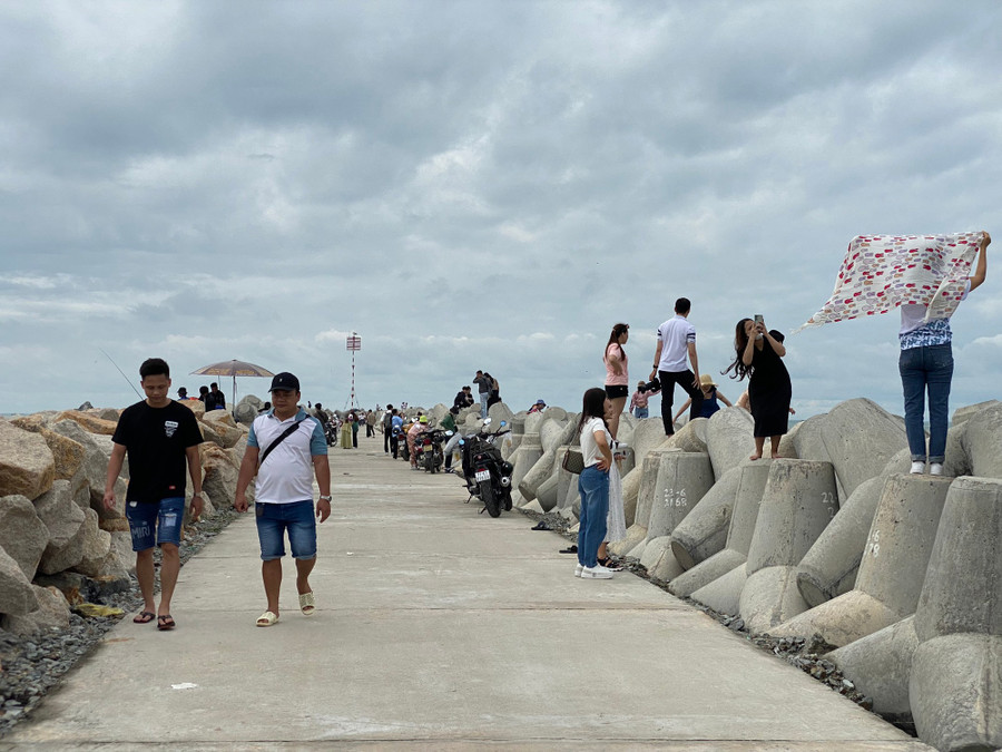 cabc21c68aff58a101ee.jpg Bờ kè có những trụ bê tông "độc lạ", thu hút nhiều người trẻ đến vui chơi. Ảnh: TẤN ĐẠT