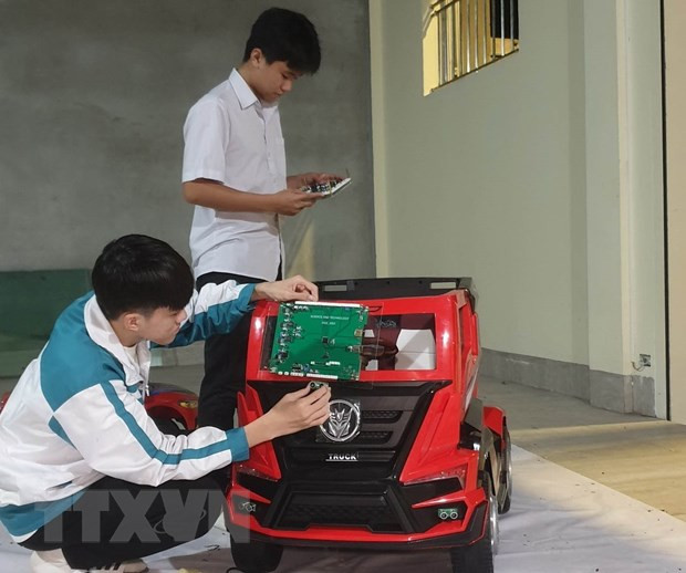 Em Phạm Đăng Minh (đứng) và Hoàng Văn Đồng nghiên cứu thực hiện đề tài. (Ảnh: Hải Yến/TTXVN) Em Phạm Đăng Minh (đứng) và Hoàng Văn Đồng nghiên cứu thực hiện đề tài. (Ảnh: Hải Yến/TTXVN)