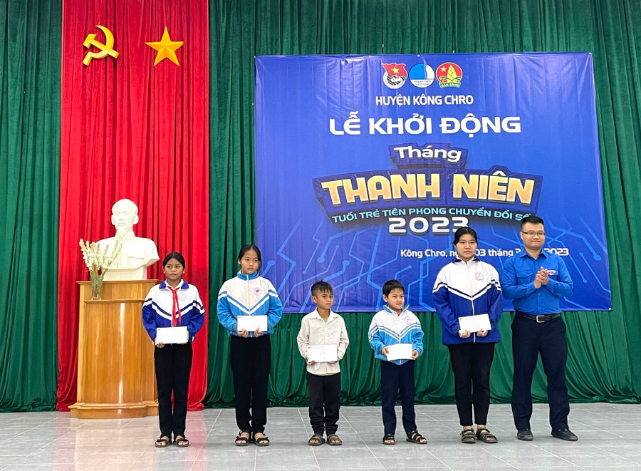 Anh Phan Đoàn Trần Hòa-Bí thư Huyện Đoàn Kông Chro (bìa phải) trao học bổng cho 5 em học sinh. Ảnh: Phương Liên