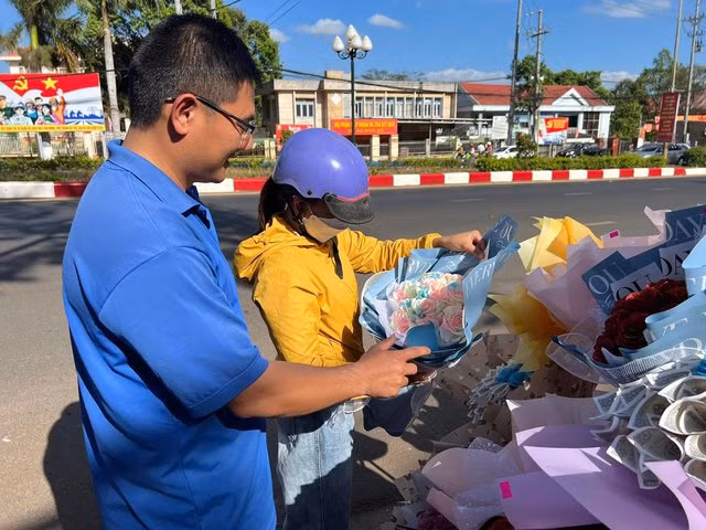 Một đoàn viên giới thiệu hoa cho khách. Ảnh: ĐOÀN P.AN BÌNH