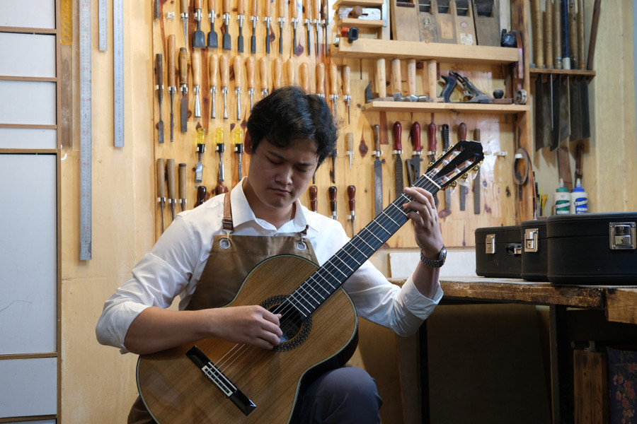 Anh Hải kiểm tra chất lượng âm thanh của một cây đàn đã làm hoàn chỉnh trước khi giao cho khách
