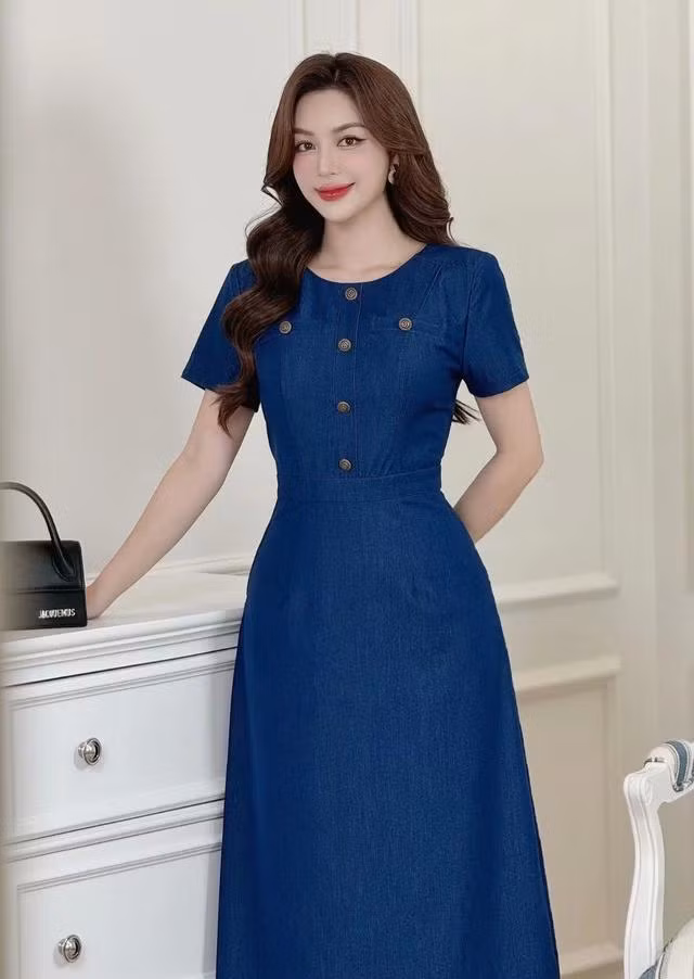 Chiếc váy được chăm chút từng chi tiết, từ đường may sắc sảo đến phom dáng ôm vừa vặn, tạo nên một diện mạo thanh lịch và quyến rũ. Phần cổ tròn tinh tế kết hợp cùng cúc ánh đồng tạo điểm nhấn độc đáo, giúp quý cô tỏa sáng và làm nổi bật phong cách riêng của mình