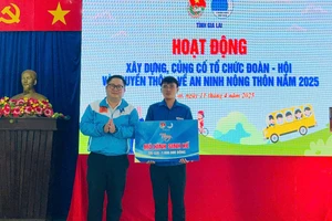 Anh Nguyễn Chí Hiếu (bìa trái, Phó Bí thư Tỉnh Đoàn, Chủ tịch Hội đồng Đội tỉnh) tặng mô hình sinh kế cho đoàn viên Đinh In (thôn Plei Pông). Ảnh: Vũ Chi