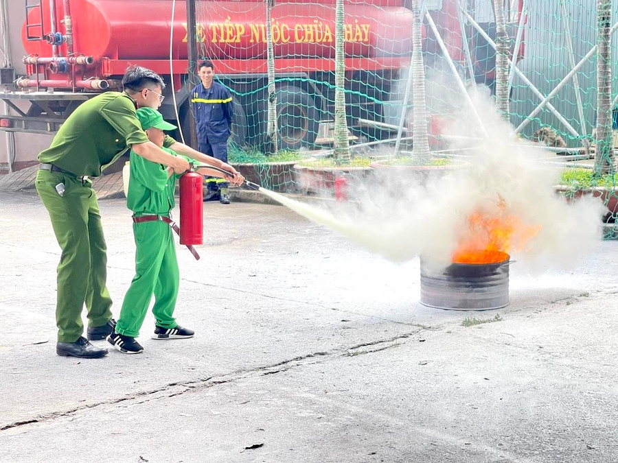 Chiến sĩ nhí được hướng dẫn cách dập tắt đám cháy nhỏ bằng bình cứu hỏa khi tham gia chương trình Học làm chiến sĩ công an. Ảnh: P.L