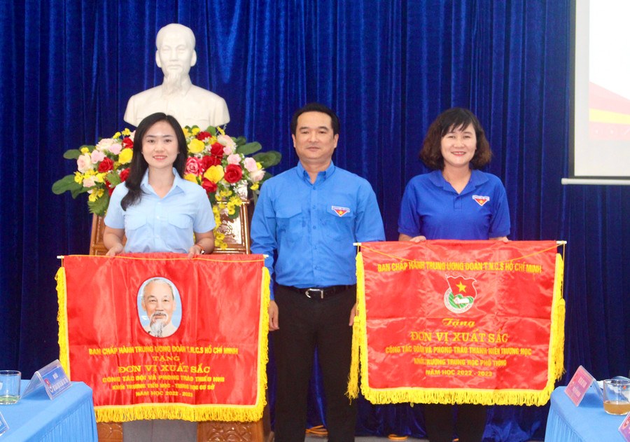 Thừa ủy quyền của Ban Chấp hành Trung ương Đoàn, anh Đỗ Duy Nam (ở giữa)-Phó Bí thư Tỉnh Đoàn trao cờ thi đua của Ban Chấp hành Trung ương Đoàn cho 2 tập thể. Ảnh: P.L