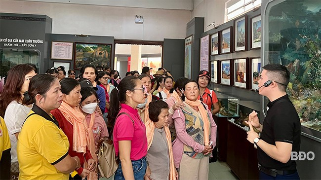 Phụ nữ mù lắng nghe hướng dẫn viên giới thiệu một số hiện vật, không gian trưng bày tại Bảo tàng tỉnh. Ảnh: D.L