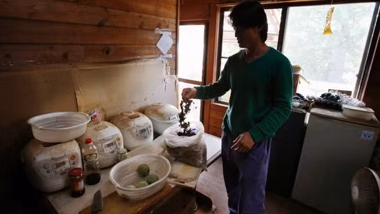 Một lao động Trung Quốc sống tại tỉnh Ibaraki (Nhật Bản) đang chuẩn bị bữa trưa cho mình. Ảnh: AP