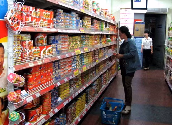 Người tiêu dùng mua thực phẩm đóng hộp tại Co.opmart Quy Nhơn. Ảnh: M.H