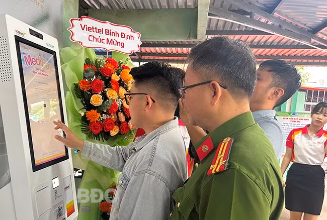 Người dân được hướng dẫn sử dụng Kiosk Y tế thông minh. Ảnh: K.A