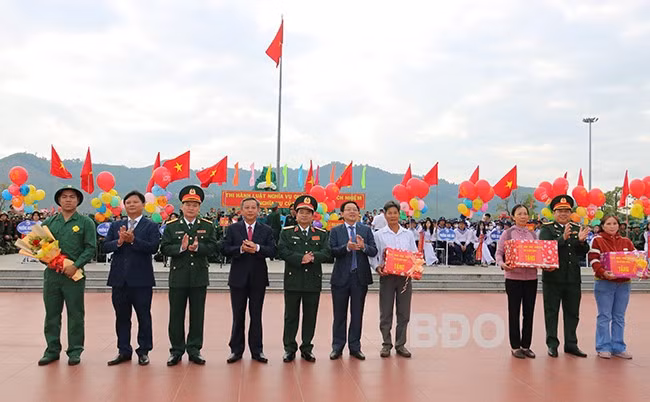 Các đồng chí lãnh đạo tặng quà cho đại diện các gia đình có con em lên đường nhập ngũ. Ảnh: H.THU