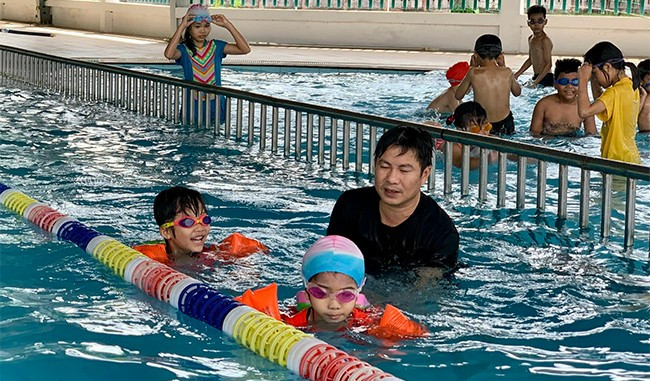 Tường Vy (em nhỏ phía trước) vui vẻ học bơi để cải thiện tình trạng “bé hạt tiêu”. Ảnh: T.K Tường Vy (em nhỏ phía trước) vui vẻ học bơi để cải thiện tình trạng “bé hạt tiêu”. Ảnh: T.K