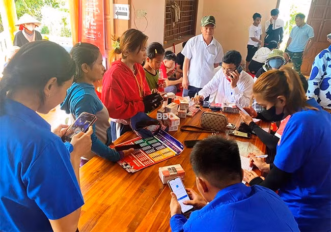 Người dân ở làng Canh Giao, xã Canh Hiệp (huyện Vân Canh) sử dụng điện thoại thông minh truy cập internet. Ảnh: ĐVCC