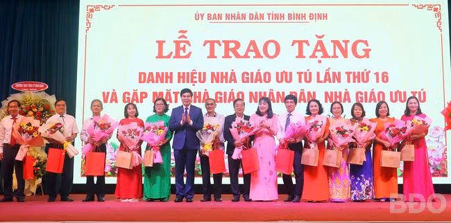 Lãnh đạo UBND tỉnh tặng hoa chúc mừng các Nhà giáo ưu tú qua các thời kỳ. Ảnh: HỒ ĐIỂM