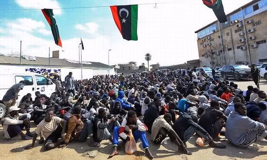 Người nhập cư châu Phi chờ đợi ở Tripoli, Libya - Ảnh: AFP