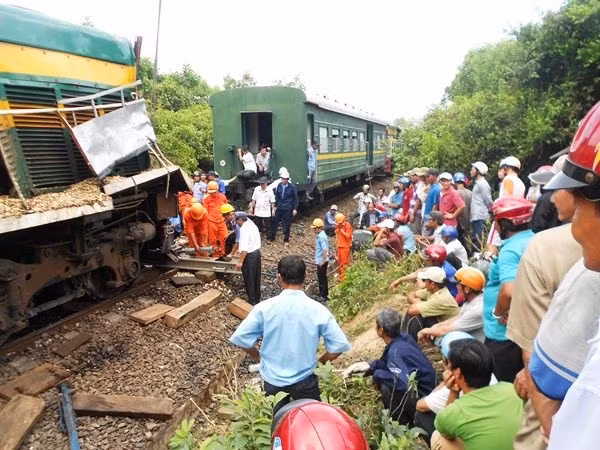 Lực lượng cứu hộ ngành đường sắt nỗ lực đưa đầu máy tàu hỏa trở lại rây. Ảnh: T.LỢI.