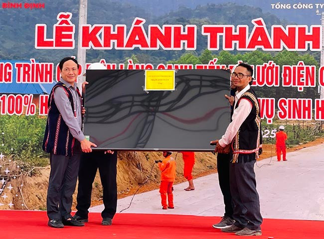 Chủ tịch UBND tỉnh Phạm Anh Tuấn (bìa trái) tặng tivi cho làng Canh Tiến. Ảnh: HẢI YẾN