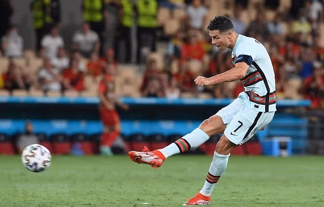 Pha sút bóng của tiền đạo Bồ Đào Nha Cristiano Ronaldo trong trận gặp tuyển Bỉ ở vòng 16 đội, chung kết EURO 2020 tại Seville, Tây Ban Nha ngày 27.6. (Ảnh: AFP/TTXVN)