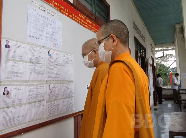 Cử tri xem lại danh sách các ứng cử viên. ẢNH: THANH TRỌN