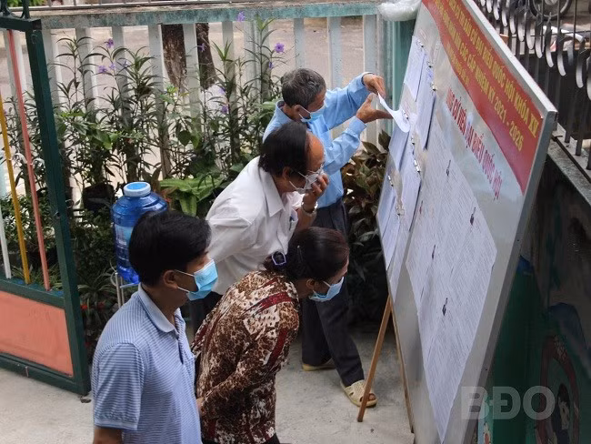 Cử tri xem tiểu sử tóm tắt của các ứng cử viên. ẢNH: VĂN TRANG