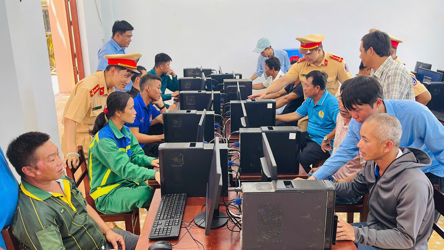 Cán bộ CSGT hướng dẫn thí sinh ôn luyện lý thuyết. Ảnh: M.N 2.jpg