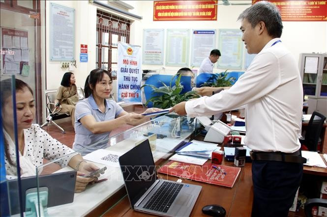 Công chức Bộ phận một cửa UBND phường Thọ Xương, thành phố Bắc Giang trả kết quả thủ tục hành chính cho người dân. Ảnh minh họa: Đồng Thúy/TTXVN Công chức Bộ phận một cửa UBND phường Thọ Xương, thành phố Bắc Giang trả kết quả thủ tục hành chính cho người dân. Ảnh minh họa: Đồng Thúy/TTXVN
