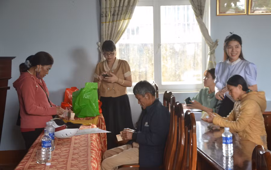 Bà con xã Nghĩa Hưng (huyện Chư Păh) nhận tiền bồi thường đất thực hiện Dự án đường hành lang kinh tế phía Đông tỉnh Gia Lai. Ảnh: Hoàng Cư