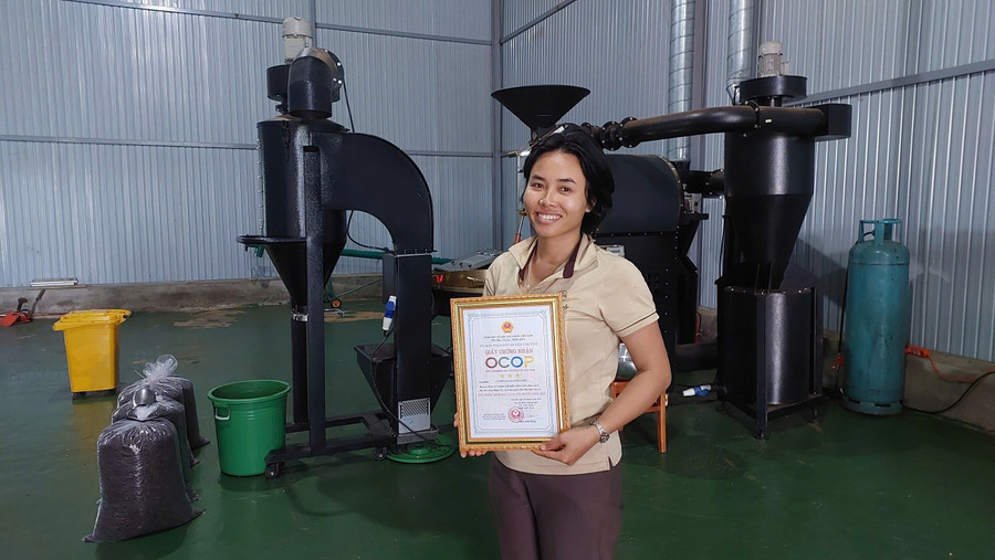 Chị Rơ Châm Awưnh-Giám đốc Công ty TNHH Chế biến nông sản Jrai Ia Ly (làng Mông Yố 1, xã Ia Phí), cùng giấy chứng nhận sản phẩm OCOP 3 sao. Ảnh: Nguyễn Diệp z6839985278279-6147d77e8b014938d240cacf7101cf4f.jpg