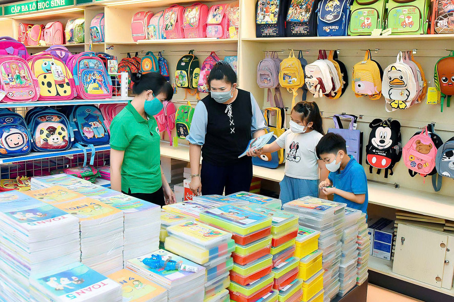 Không ít phụ huynh tạo niềm vui và sự háo hức cho con bằng việc đưa con đi mua sắm sách vở, đồ dùng cho năm học. Ảnh: Đức Thụy