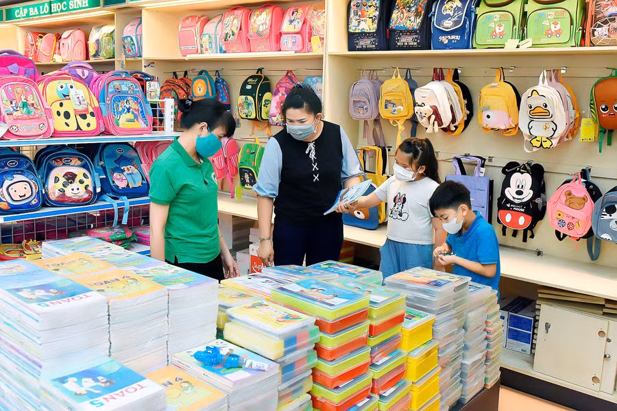 Không ít phụ huynh tạo niềm vui và sự háo hức cho con bằng việc đưa con đi mua sắm sách vở, đồ dùng cho năm học. Ảnh: Đức Thụy