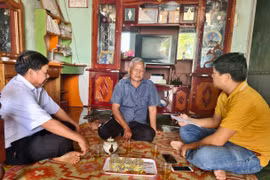 Già làng Deo (giữa) chia sẻ những đổi thay của làng sau khi triển khai xây dựng làng nông thôn mới. Ảnh: Lê Nam