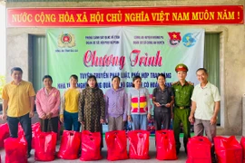 Ban tổ chức tặng quà cho các hộ gia đình có hoàn cảnh khó khăn trên địa bàn thị trấn Phú Túc. Ảnh: Vũ Chi