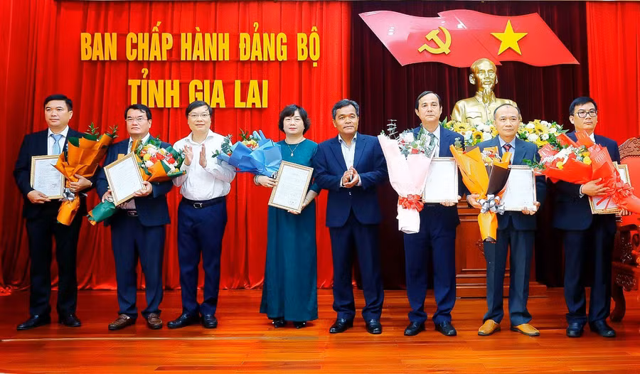 Bí thư Tỉnh ủy Hồ Văn Niên (thứ 5 từ trái sang) và Chủ tịch UBND tỉnh Trương Hải Long (thứ 3 từ trái sang) trao quyết định, tặng hoa chúc mừng các cán bộ được điều động, bổ nhiệm. Ảnh: Đ.T