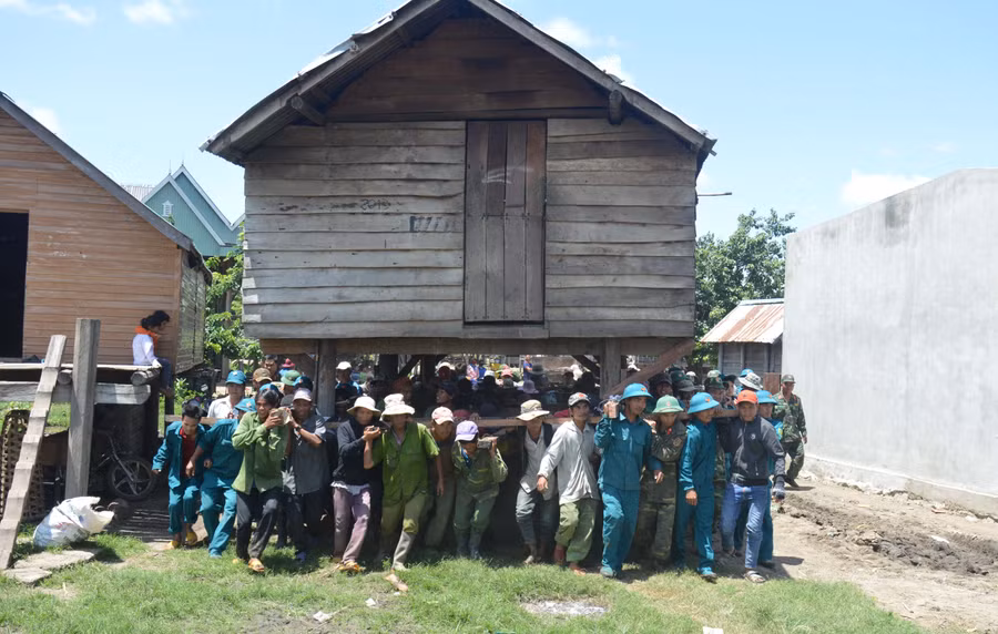 Người dân làng Bi Giông (xã Pờ Tó, huyện Ia Pa) cùng bộ đội di dời nhà sàn về nơi ở mới. Ảnh: P.D