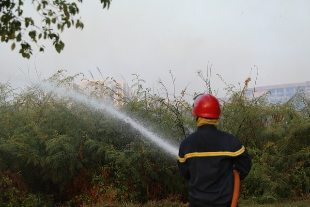 Cảnh sát chữa cháy phun nước làm mát tránh cháy lan.