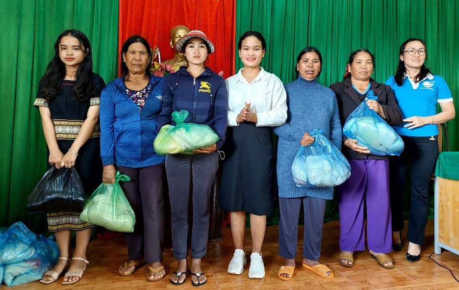 Chị H'Tinh (giữa) phát gạo cho những gia đình khó khăn. Ảnh: Phạm Ngọc Chị H'Tinh (giữa) phát gạo cho những gia đình khó khăn. Ảnh: Phạm Ngọc