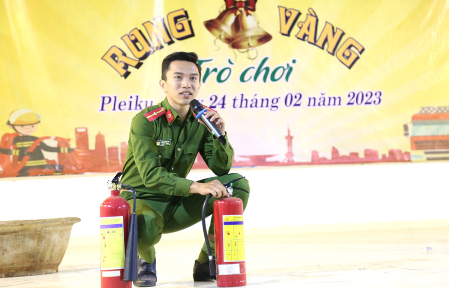 Cán bộ Đội cảnh sát PCCC và CNCH Công an TP. Pleiku hướng dẫn các em học sinh sử dụng bình chữa cháy. Ảnh: Hữu Trường
