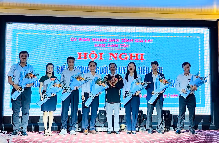 Lãnh đạo Ban Dân tộc tỉnh tặng hoa cảm ơn các cơ quan, doanh nghiệp đã hỗ trợ xe đạp cho các em học sinh người DTTS. Ảnh: Hải Bình