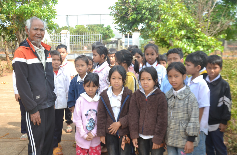 Ông Han (bên trái) tuyên truyền, vận động các cháu thiếu nhi ở làng Chăm Nek đi học chuyên cần. Ảnh: H.M Ông Han (bên trái) tuyên truyền, vận động các cháu thiếu nhi ở làng Chăm Nek đi học chuyên cần. Ảnh: H.M