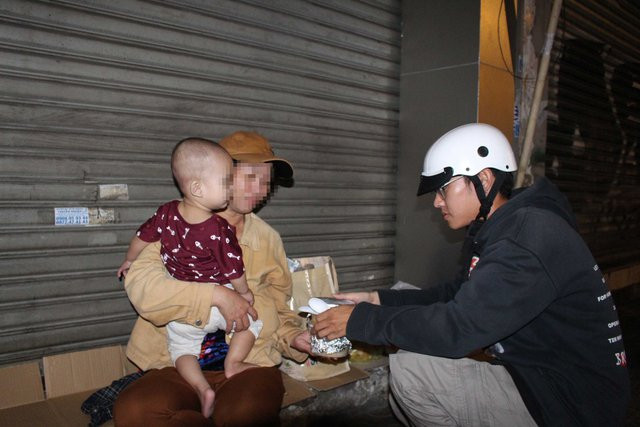 Em bé 10 tháng tuổi cùng mẹ qua đêm tại vỉa hè nhận cháo của nhóm thiện nguyện. Ảnh: Quang Viên Em bé 10 tháng tuổi cùng mẹ qua đêm tại vỉa hè nhận cháo của nhóm thiện nguyện. Ảnh: Quang Viên