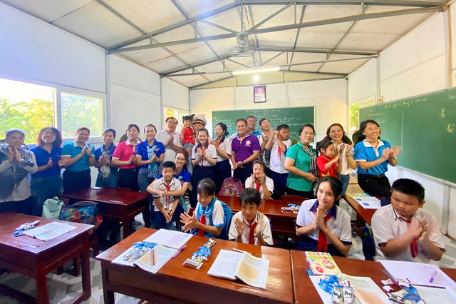 Biển đảo Tây Nam: Nơi 'cuốn theo chiều gió' - Ảnh 2. Các đại biểu đoàn công tác chụp hình lưu niệm với các em học sinh ở Hòn Chuối. Ảnh: THU NGÂN