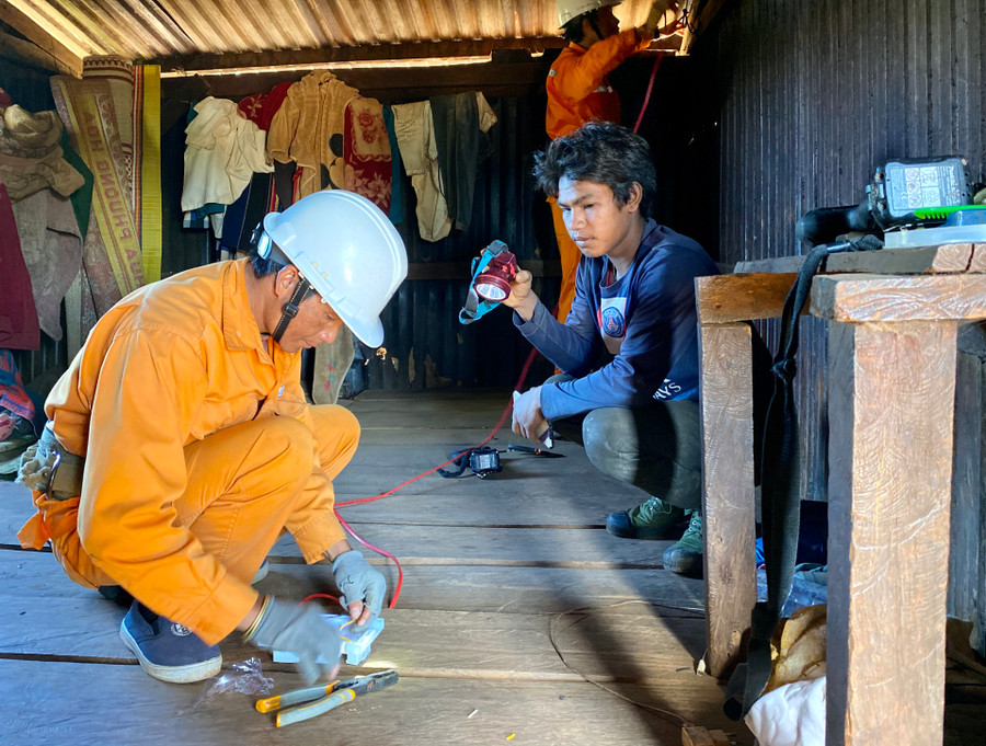 Công nhân Điện lực Pleiku sửa chữa điện miễn phí cho người dân làng D (xã Gào, TP. Pleiku). Ảnh: Hà Duy