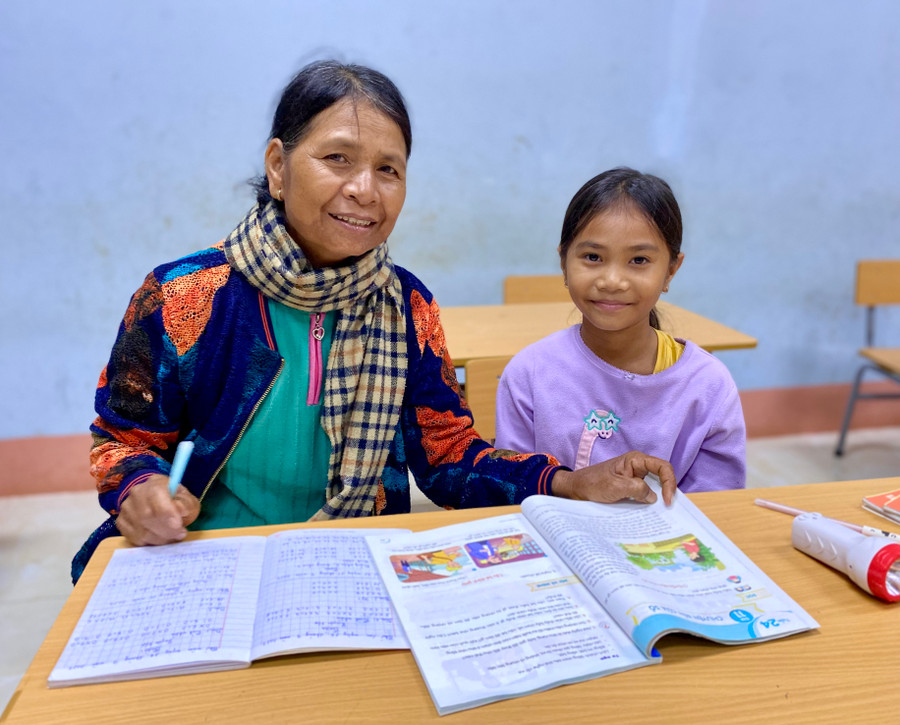 Bố bỏ đi, mẹ lấy chồng khác, cô bé H&apos;Nư, 9 tuổi (làng Lang, phường Chi Lăng) từ nhỏ đã phải sống với bà ngoại. Vì hoàn cảnh khó khăn, không có tiền đi học, nên để biết được cái chữ, mỗi tối, cô bé lại theo chân bà đến lớp học xóa mù chữ được tổ chức ở làng Lang.