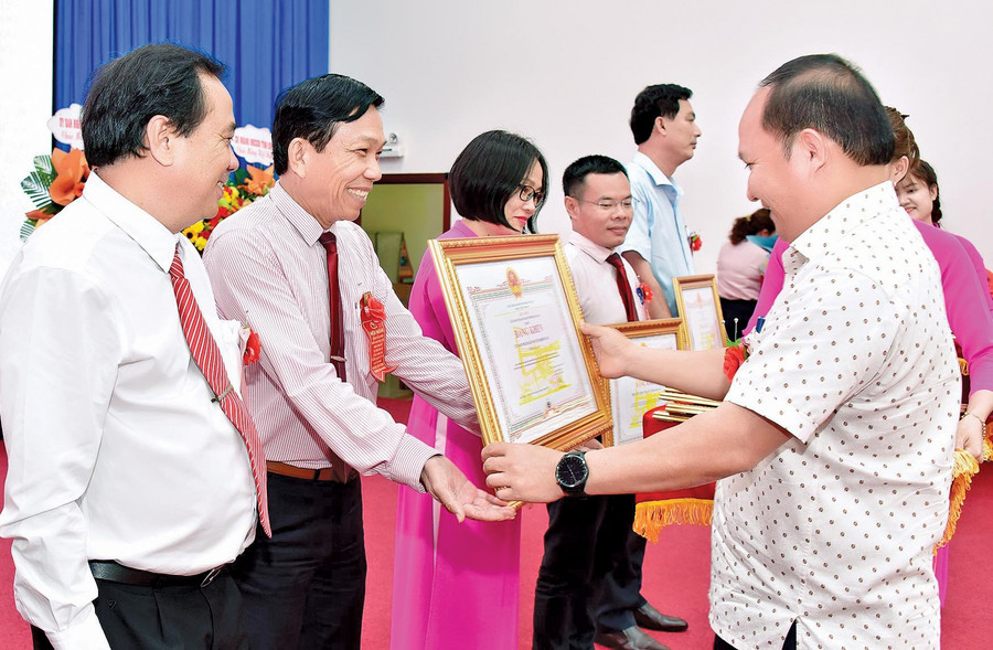 Phó Bí thư Tỉnh ủy Rah Lan Chung trao quyết định khen thưởng đối với các cá nhân có nhiều thành tích xuất sắc trong 20 năm thực hiện Nghị định số 78 của Chính phủ về tín dụng chính sách. Ảnh: Sơn Ca