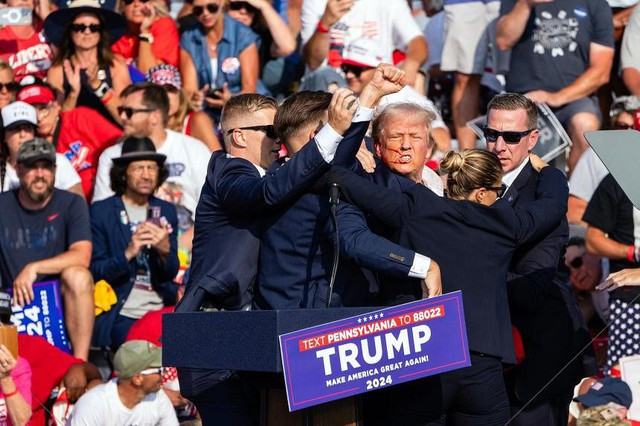 Mật vụ Mỹ chạy lên sâu khấu ngay khi cựu Tổng thống Donald Trump trúng đạn tại sự kiện vận động tranh cử hôm 13-7 ở TP Butler. Ảnh: New York Times