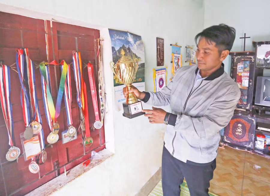 Ông Khôn khoe chiếc cúp con trai giành được khi thi đấu. Ảnh: Lê Gia Ông Khôn khoe chiếc cúp con trai giành được khi thi đấu. Ảnh: Lê Gia