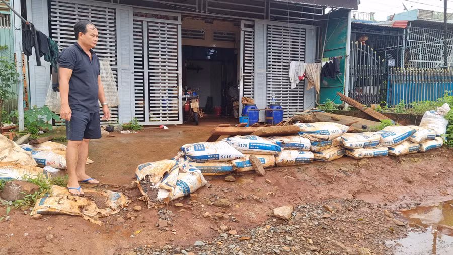Người dân nơi đây dùng bao cát, đắp kè chắn trước cổng nhà để ngăn nước. Ảnh: Hà Phương
