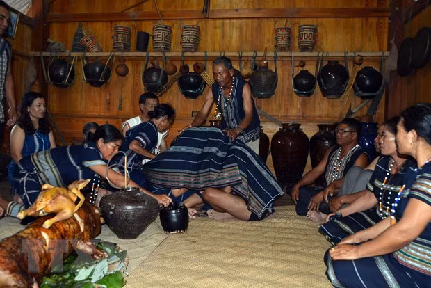 Nghi lễ trùm khăn cho cô dâu, chú rể trong đám cưới. Ảnh: Chu Quốc Hùng/TTXVN