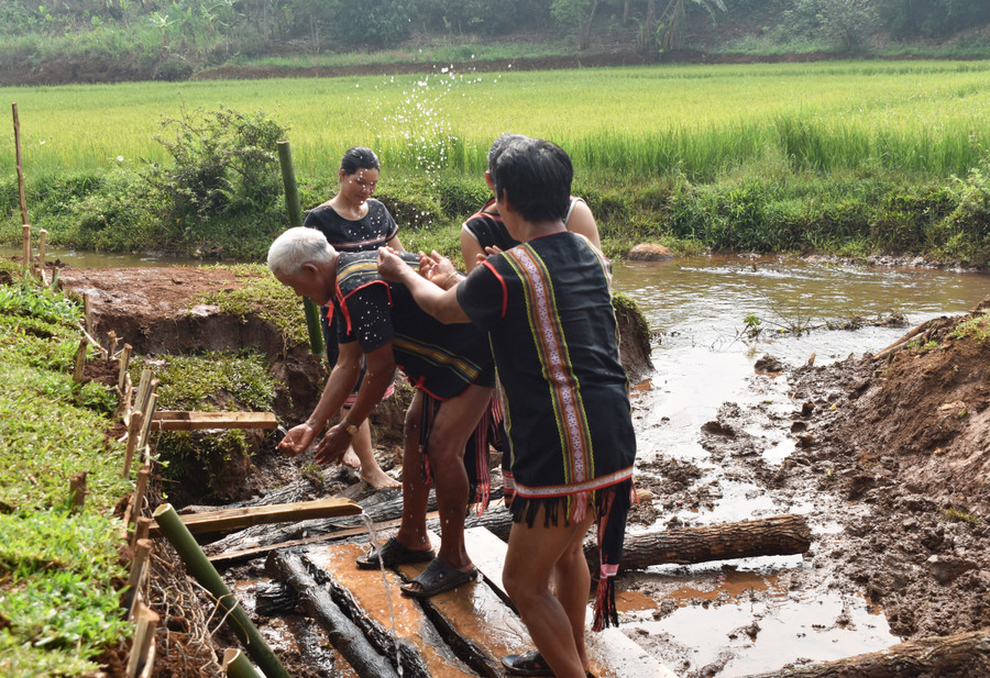 Già làng cùng người làng té nước để cầu mong sự may mắn. Ảnh: Minh Thoan Già làng cùng người làng té nước để cầu mong sự may mắn. Ảnh: Minh Thoan