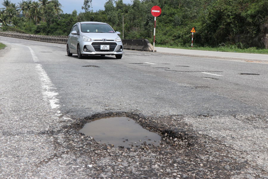 Những cái bẫy từ &quot;ổ voi&quot;, &quot;ổ gà&quot; luôn trực chờ người tham gia giao thông trên tuyến quốc lộ 1, đoạn qua phường Phổ Thạnh. Ảnh: Ngọc Viên