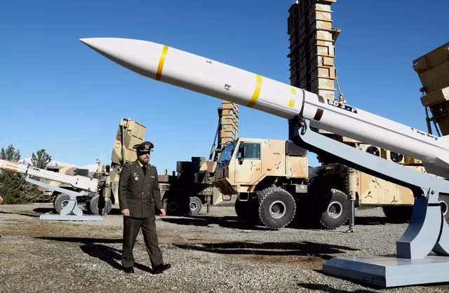 Bộ trưởng Quốc phòng Iran Mohammad-Reza Ashtiani đi gần một tên lửa của Iran. Ảnh: Reuters